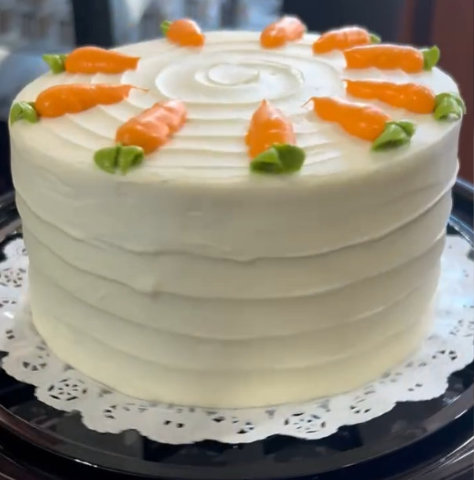 A cake with a carrot and a piece of cake showcasing oreo tres leches.