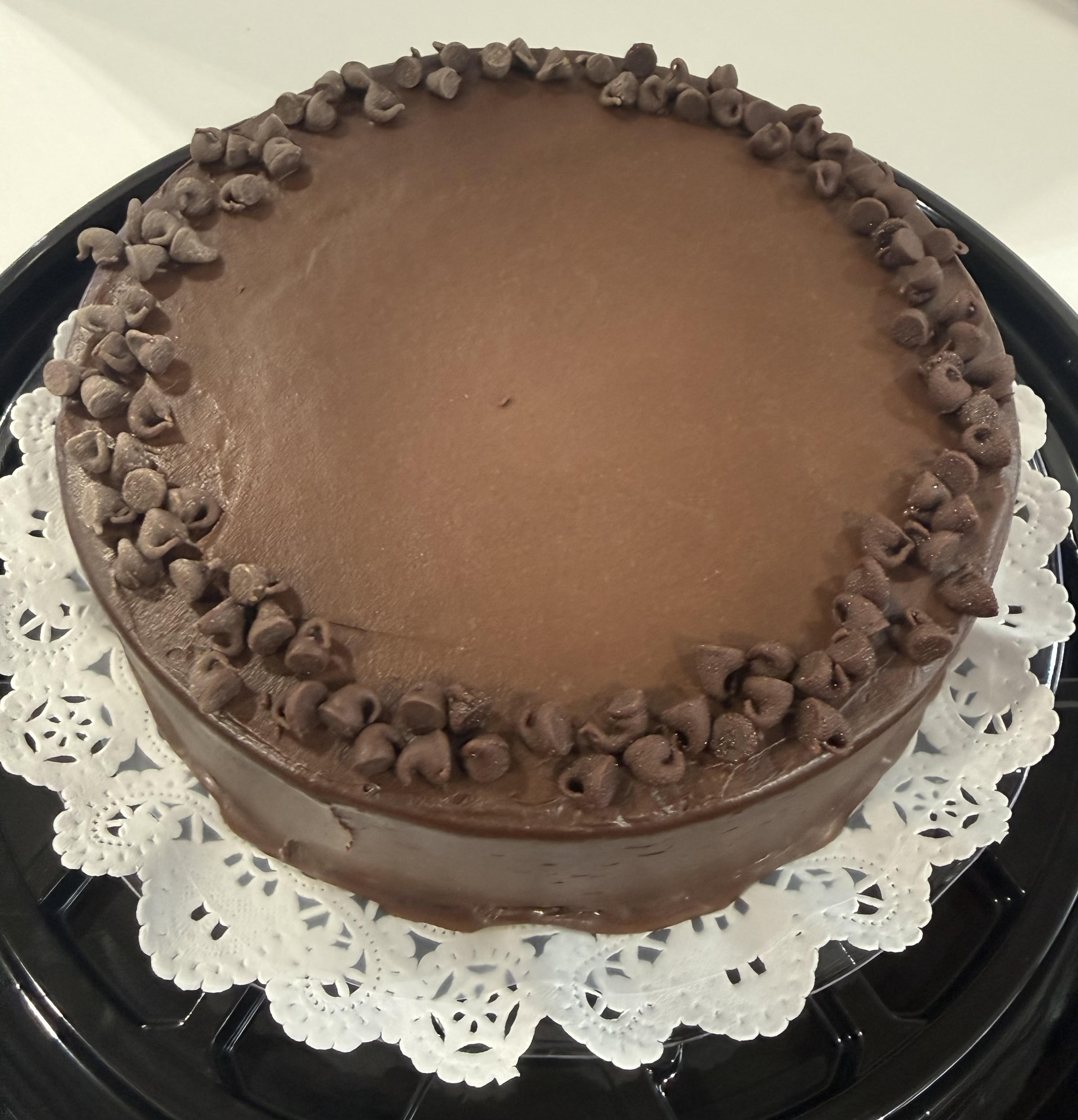 A cake with a lot of frosting on it showcasing mango tres leches.