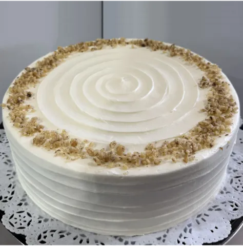 A cake with a carrot and a piece of cake showcasing oreo tres leches.