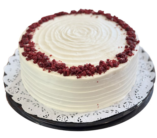 A cake with a carrot and a piece of cake showcasing oreo tres leches.