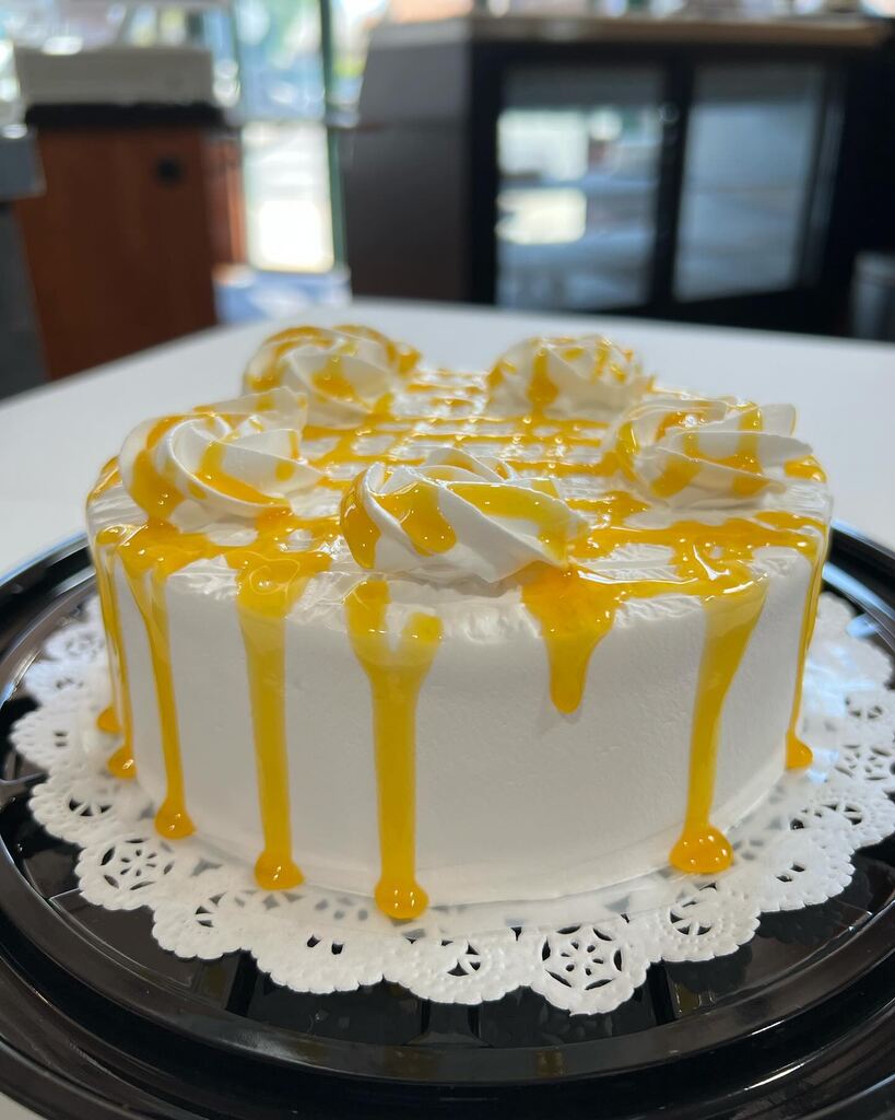 A white cake with a blue frosting on it showcasing rumchata tres leches.