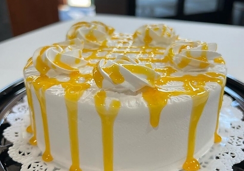 A white cake with a blue frosting on it showcasing rumchata tres leches.
