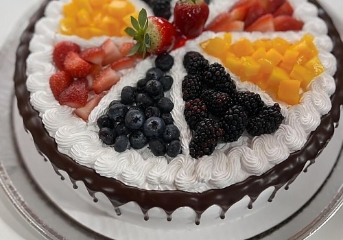 A cake with a frosting on top of it showcasing tres leches cake.