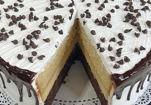 A cake with a frosting on top of it showcasing wedding cakes.