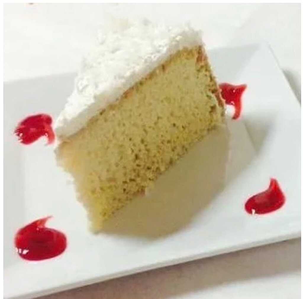 A piece of cake with a slice cut out of it showcasing custom cakes.