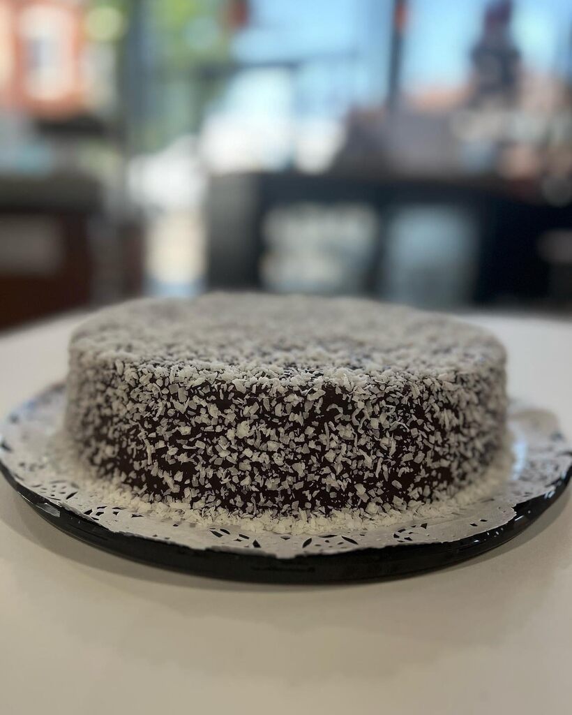 A cake with a piece of cake on top of it showcasing chicago bakery.