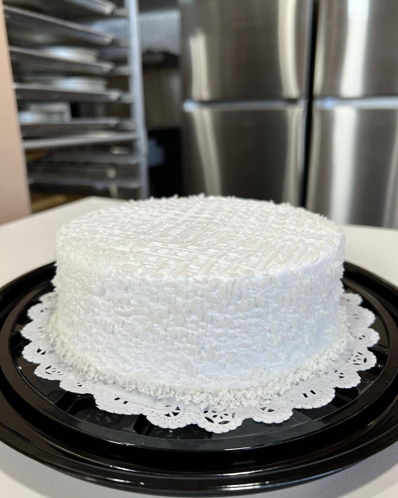 A white cake with a white frosting on top showcasing rumchata tres leches.