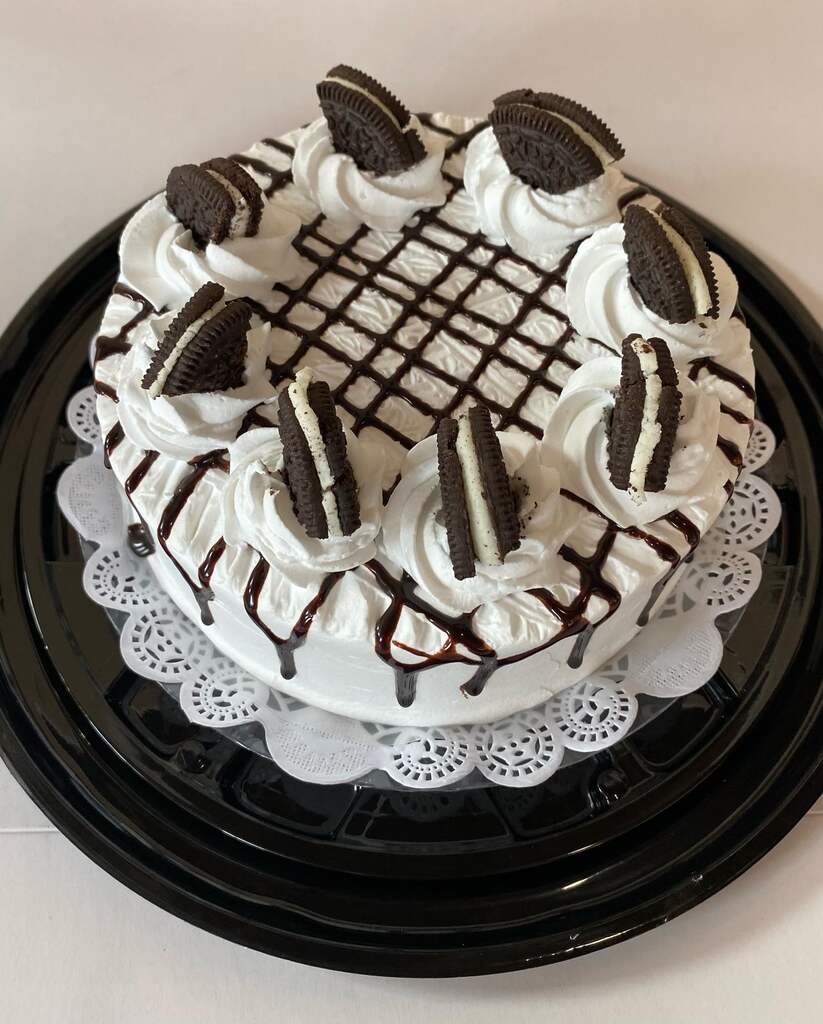 A cake with a bunch of candles on it showcasing cappuccino tres leches.