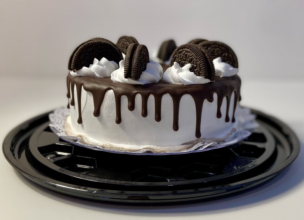 A cake with a oreos on top of it showcasing wedding cakes.